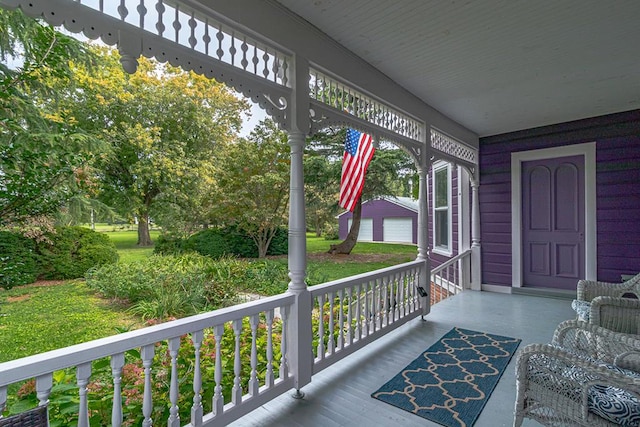 wooden terrace with a porch and a garage