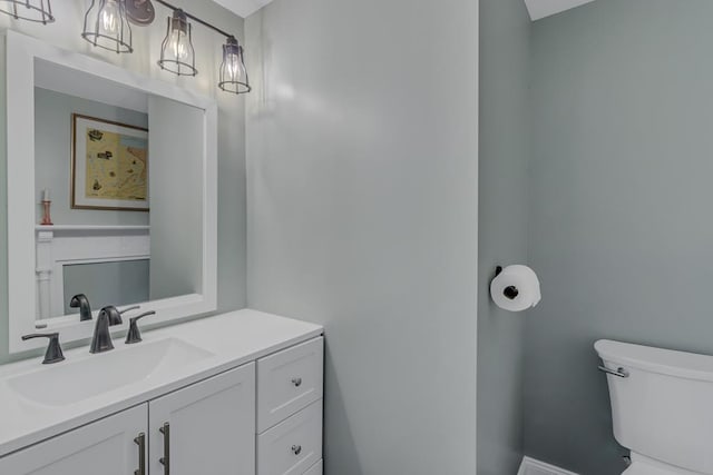 bathroom featuring toilet and vanity