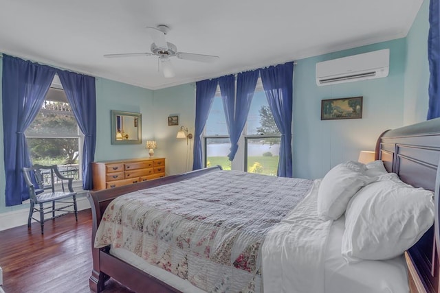 bedroom featuring ceiling fan, a wall mounted AC, and wood finished floors