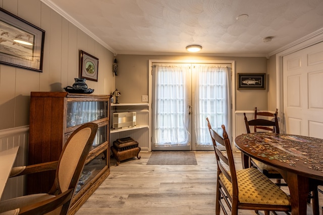 interior space featuring french doors, a textured ceiling, light hardwood / wood-style floors, and crown molding