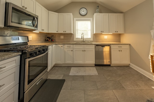 kitchen featuring white cabinets, sink, lofted ceiling, and stainless steel appliances