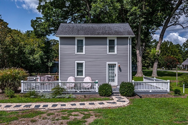 rear view of property with a yard