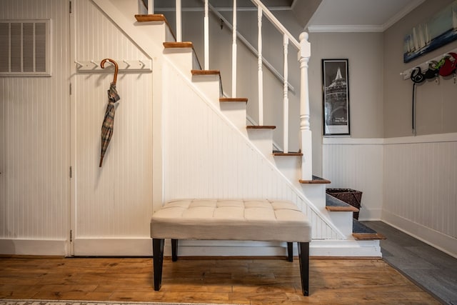 mudroom featuring wood-type flooring and ornamental molding