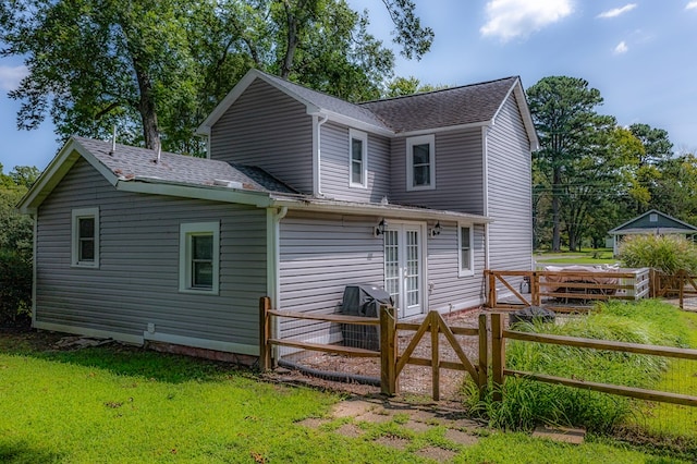 rear view of house featuring a yard