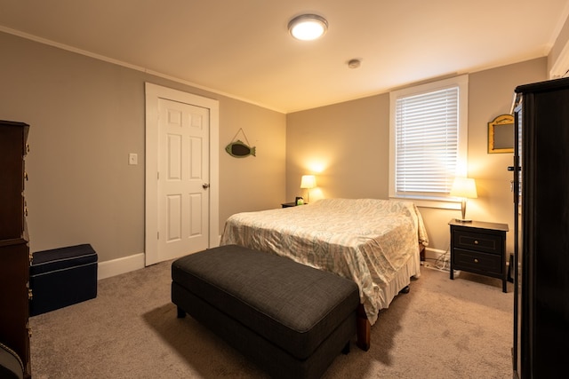 bedroom featuring light colored carpet and ornamental molding