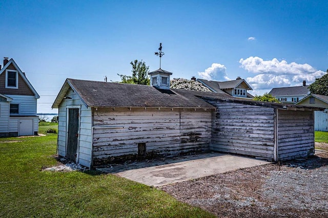 view of outbuilding with a yard