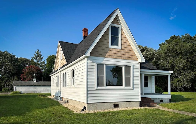 exterior space with covered porch and a yard