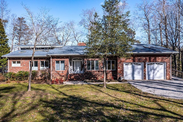 single story home featuring a front lawn and a garage