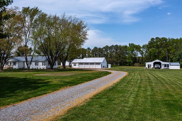 2920 Newmans Neck Rd, Heathsville, VA 22473 - view of grassy yard featuring gravel driveway, an attached garage, and an outdoor structure