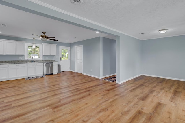 2920 Newmans Neck Rd, Heathsville, VA 22473 - unfurnished living room featuring baseboards, light wood-style floors, a sink, ceiling fan, and a textured ceiling