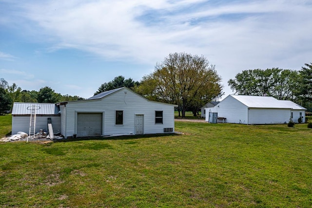 2920 Newmans Neck Rd, Heathsville, VA 22473 - back of house featuring an outdoor structure, an attached garage, a yard, and a pole building