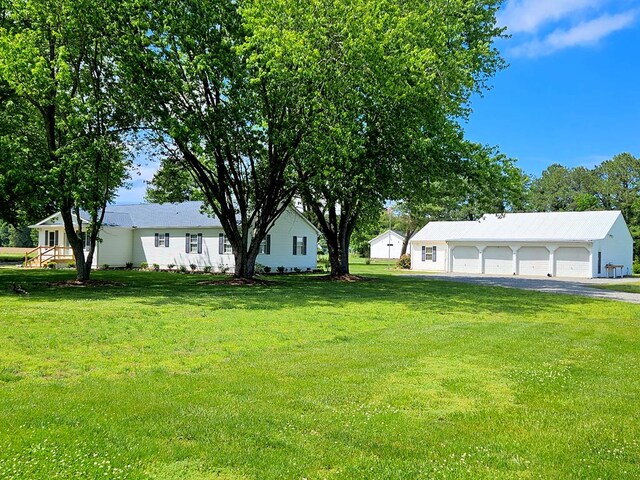 2920 Newmans Neck Rd, Heathsville, VA 22473 - view of green lawn with a detached garage and an outdoor structure
