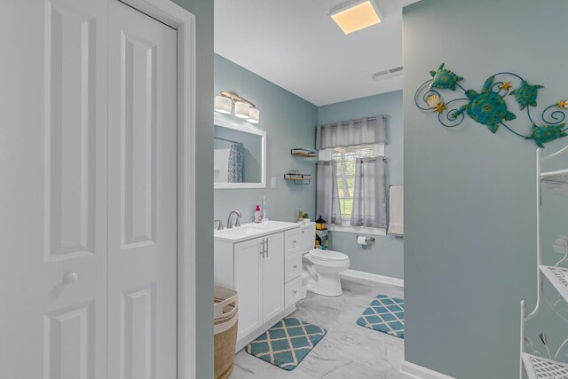 2920 Newmans Neck Rd, Heathsville, VA 22473 - full bathroom with marble look tiles, vanity, baseboards, and toilet