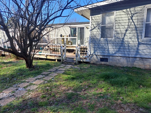 exterior space featuring a yard and a wooden deck