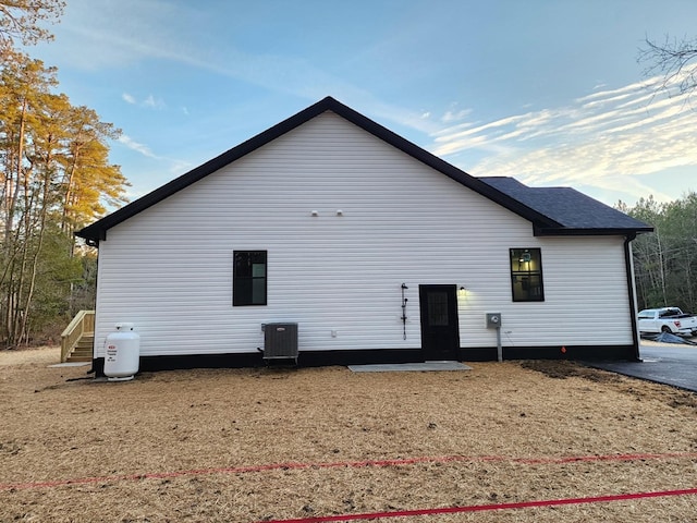 back of house featuring cooling unit