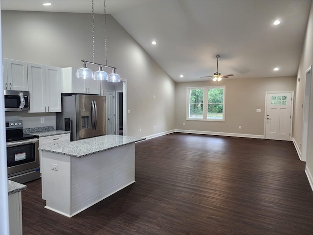 kitchen featuring a center island, dark hardwood / wood-style floors, pendant lighting, white cabinets, and appliances with stainless steel finishes