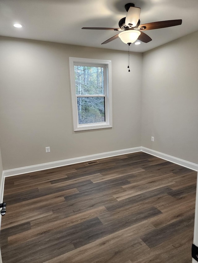 unfurnished room featuring dark hardwood / wood-style floors and ceiling fan