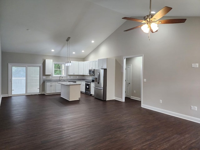 kitchen featuring a center island, white cabinets, sink, hanging light fixtures, and appliances with stainless steel finishes