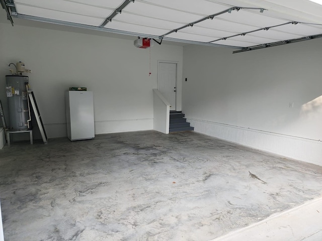 garage with electric water heater and a garage door opener