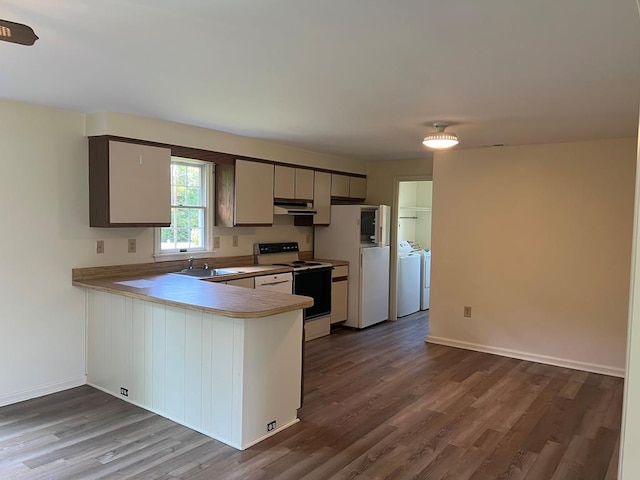 827 Travelers Rest Rd, Hague, VA 22469 - kitchen with white appliances, washing machine and dryer, dark wood finished floors, a peninsula, and under cabinet range hood