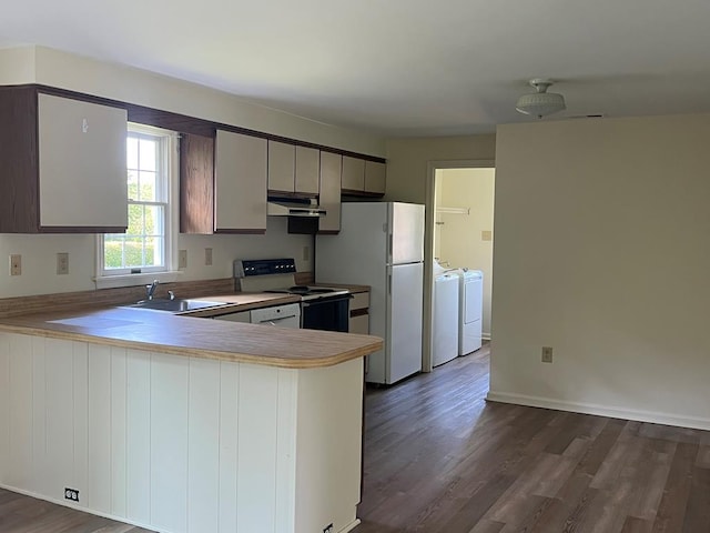 827 Travelers Rest Rd, Hague, VA 22469 - kitchen featuring independent washer and dryer, electric range oven, under cabinet range hood, freestanding refrigerator, and dark wood-style floors