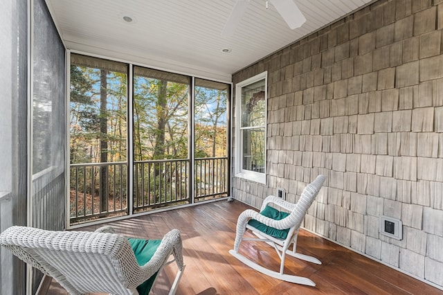 sunroom / solarium featuring ceiling fan