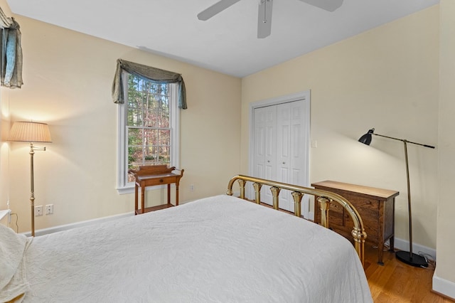 bedroom featuring ceiling fan, a closet, and wood-type flooring