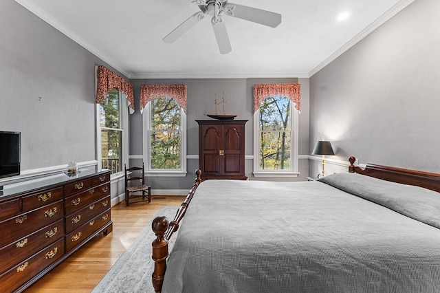 bedroom with ceiling fan, light hardwood / wood-style floors, and crown molding