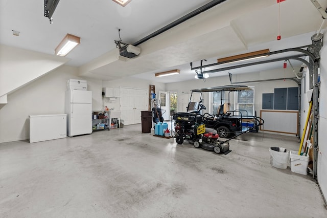 garage featuring electric panel, white fridge, a garage door opener, and fridge