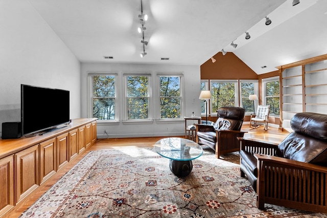 living room with lofted ceiling, track lighting, and light wood-type flooring