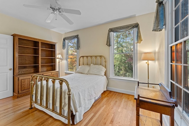 bedroom with ceiling fan and light hardwood / wood-style floors