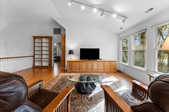 living room featuring light hardwood / wood-style floors and lofted ceiling