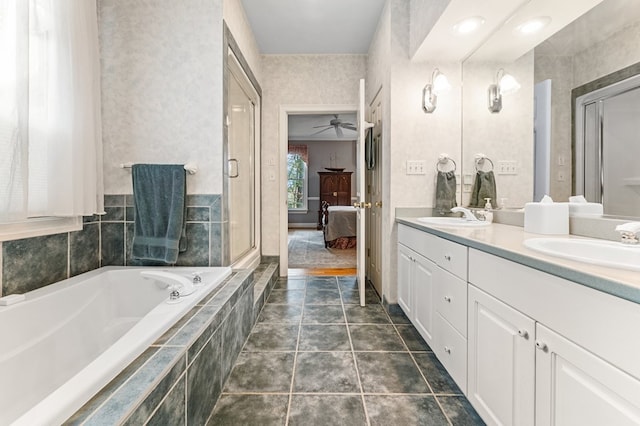 bathroom featuring tile patterned floors, tiled bath, ceiling fan, and vanity