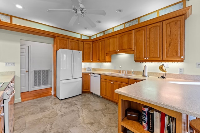 kitchen featuring ceiling fan, sink, and white appliances