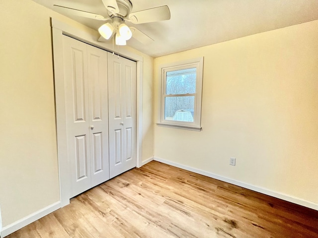 unfurnished bedroom featuring ceiling fan, a closet, and light hardwood / wood-style floors