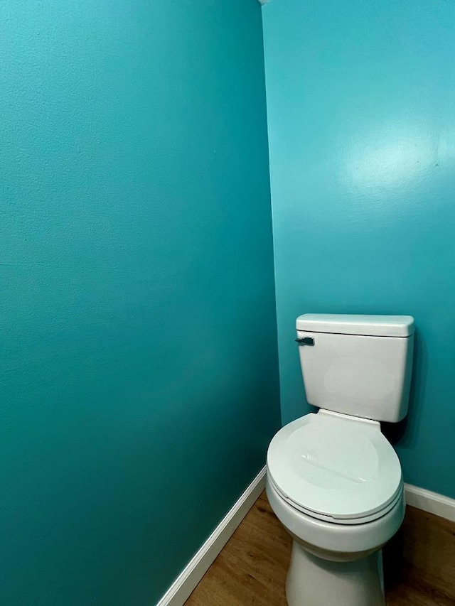 bathroom featuring wood-type flooring and toilet