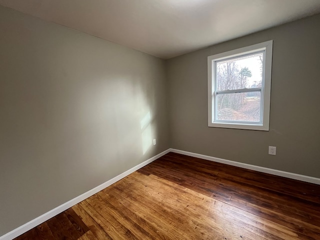 spare room featuring dark hardwood / wood-style flooring