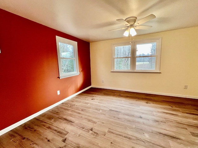 spare room with ceiling fan and light wood-type flooring