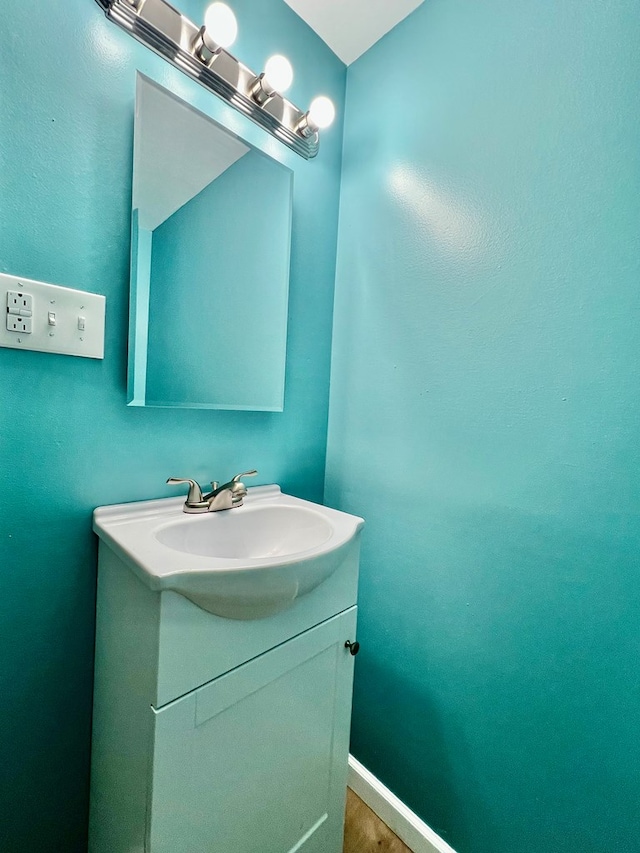 bathroom with hardwood / wood-style floors and vanity