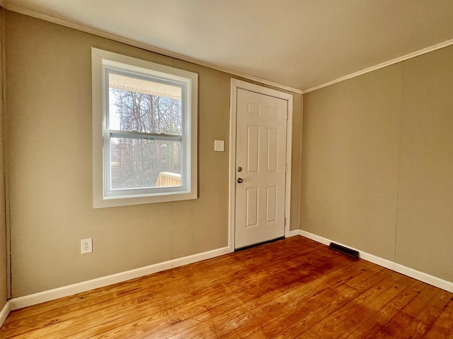 interior space featuring light wood-type flooring and ornamental molding