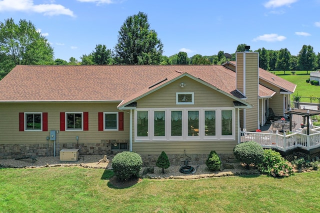 309 Nomini Bay Dr, Montross, VA 22520 - back of property featuring a deck, a yard, a chimney, and roof with shingles