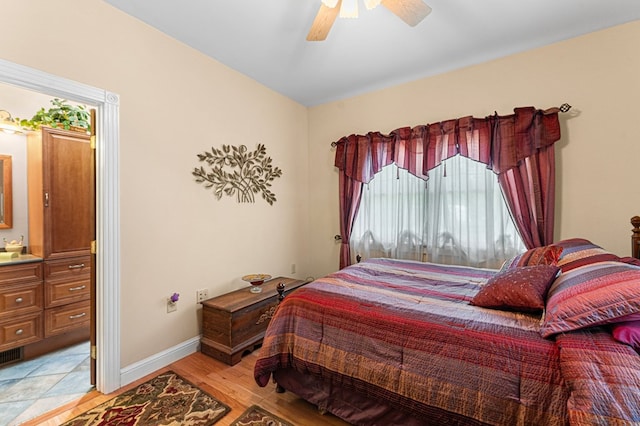 309 Nomini Bay Dr, Montross, VA 22520 - bedroom with a ceiling fan, connected bathroom, and light wood finished floors