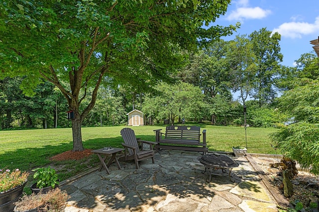 309 Nomini Bay Dr, Montross, VA 22520 - view of patio with a storage shed, a fire pit, and view of scattered trees