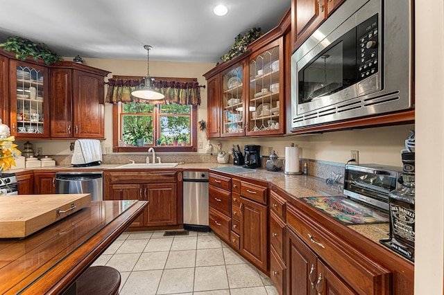 309 Nomini Bay Dr, Montross, VA 22520 - kitchen featuring stainless steel appliances, tile counters, hanging light fixtures, light tile patterned floors, and glass insert cabinets