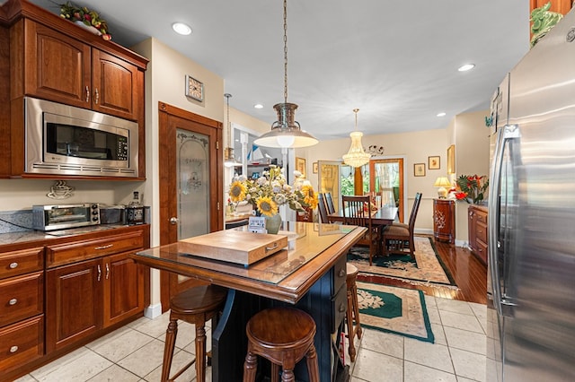309 Nomini Bay Dr, Montross, VA 22520 - kitchen with appliances with stainless steel finishes, recessed lighting, light tile patterned floors, decorative light fixtures, and a chandelier