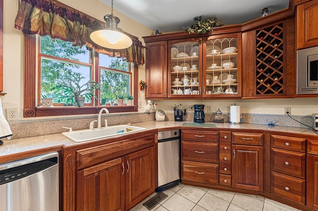 309 Nomini Bay Dr, Montross, VA 22520 - kitchen with stainless steel appliances, light tile patterned floors, glass insert cabinets, tile counters, and plenty of natural light