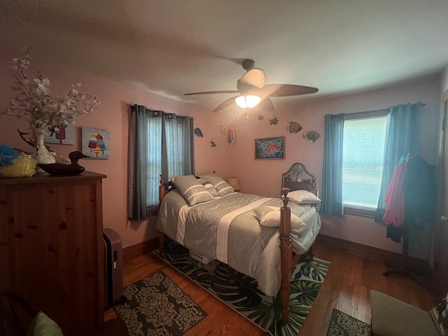 bedroom featuring wood finished floors, ceiling fan, and baseboards