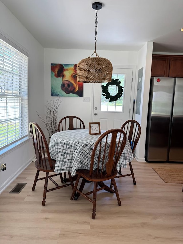 230 Roseneath Ave, Kilmarnock, VA 22482 - dining room with healthy amount of natural light, light wood-type flooring, and baseboards