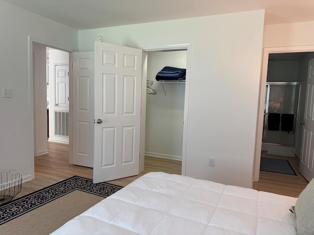 230 Roseneath Ave, Kilmarnock, VA 22482 - bedroom featuring wood finished floors, baseboards, a closet, and connected bathroom