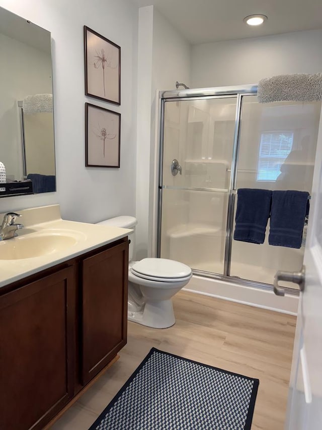 230 Roseneath Ave, Kilmarnock, VA 22482 - full bath featuring vanity, a stall shower, wood finished floors, toilet, and recessed lighting